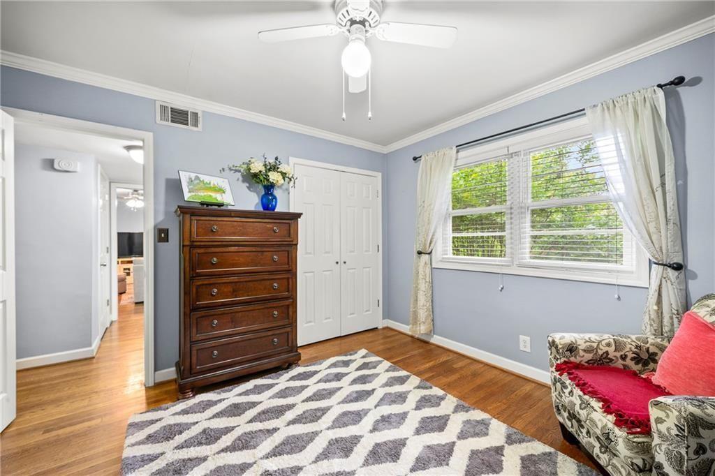 3660 Peachtree Road Northeast, Unit 6A Atlanta, GA 30319 - Photo 11 of 13 a bedroom with a bed and wooden floor