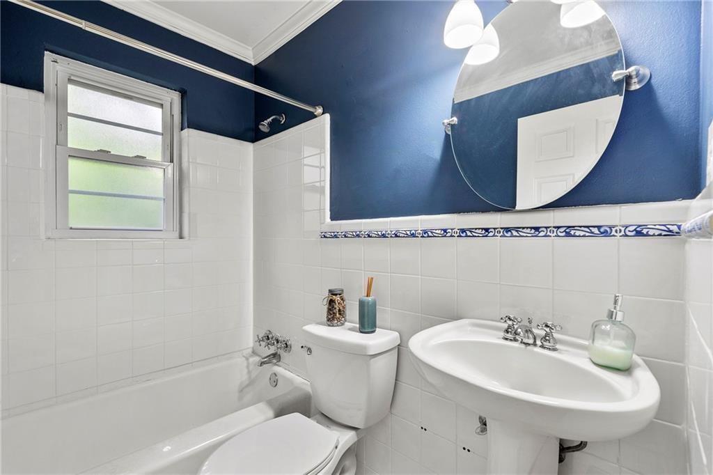 3660 Peachtree Road Northeast, Unit 6A Atlanta, GA 30319 - Photo 12 of 13 a bathroom with a sink a toilet and mirror