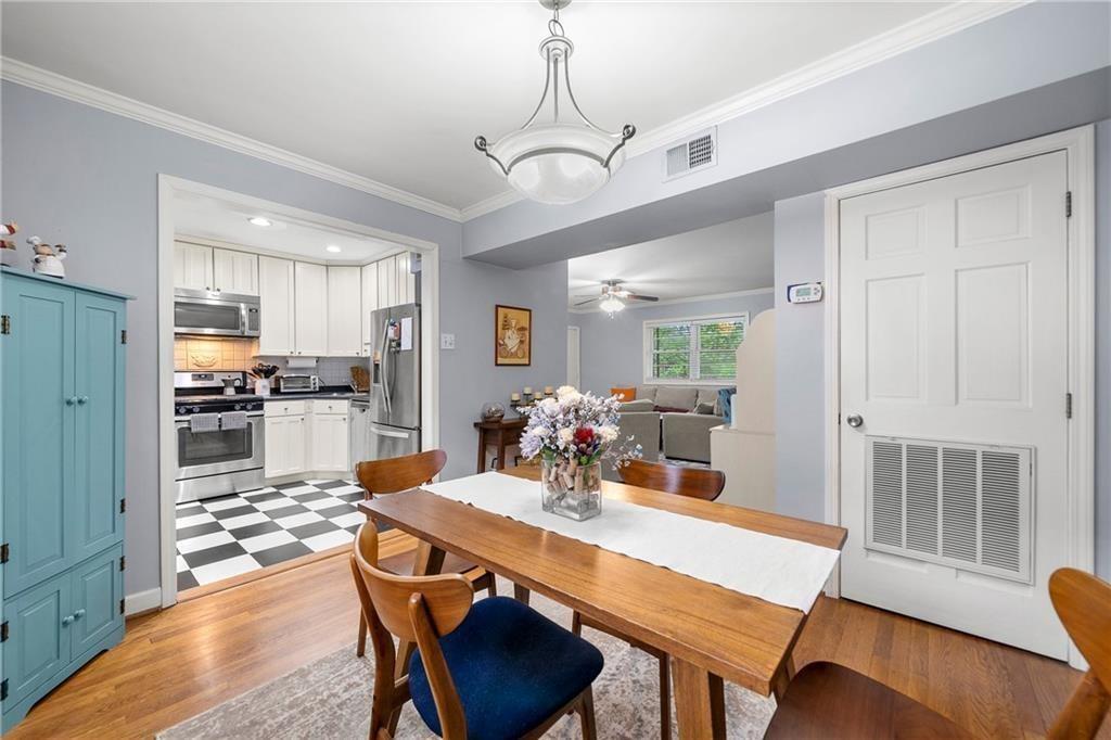 3660 Peachtree Road Northeast, Unit 6A Atlanta, GA 30319 - Photo 5 of 13 a view of a dining room with furniture wooden floor and chandelier