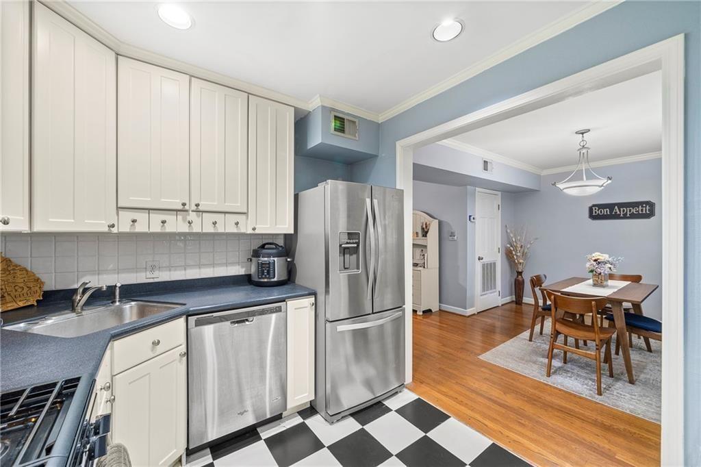 3660 Peachtree Road Northeast, Unit 6A Atlanta, GA 30319 - Photo 7 of 13 a kitchen with stainless steel appliances a refrigerator and cabinets