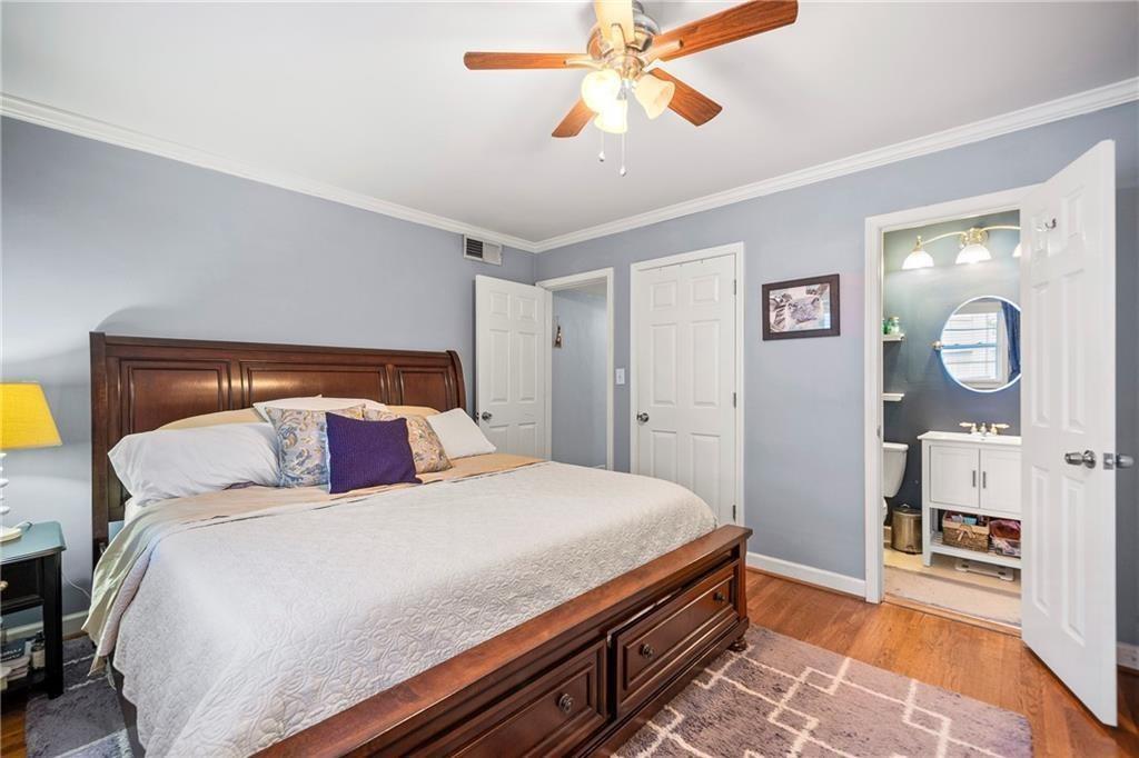 3660 Peachtree Road Northeast, Unit 6A Atlanta, GA 30319 - Photo 8 of 13 a bedroom with a bed and a chandelier