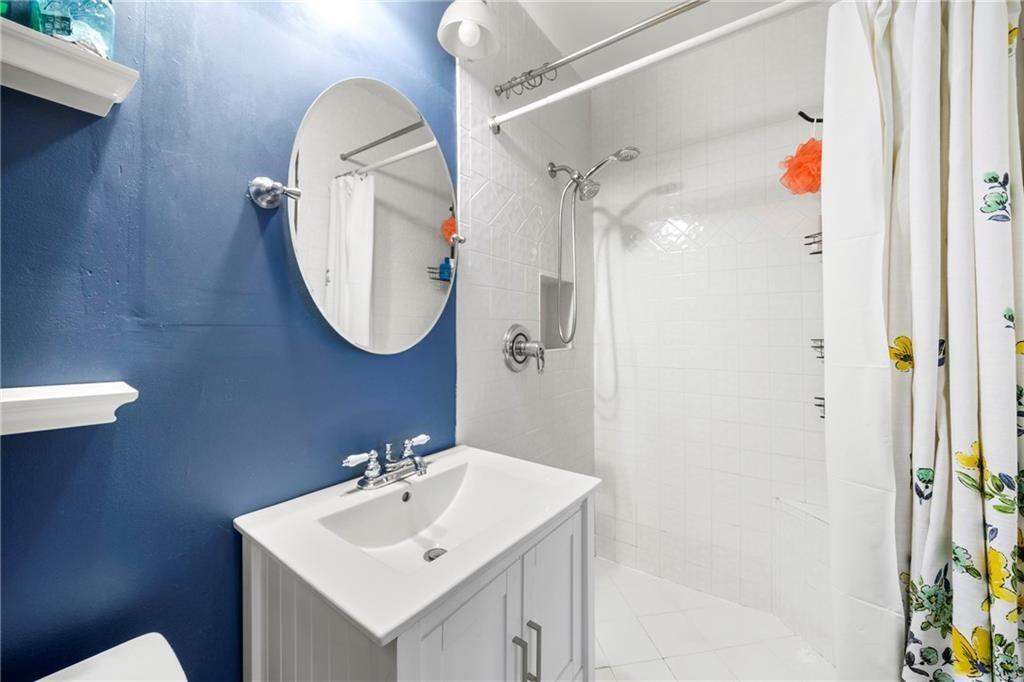 3660 Peachtree Road Northeast, Unit 6A Atlanta, GA 30319 - Photo 10 of 13 a bathroom with a sink mirror and shower