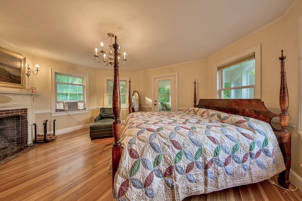 13 Spaulding Road Shirley, MA 01464 - Photo 15 of 27 a bedroom with a bed wooden floor and chandelier