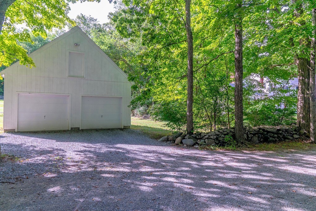 13 Spaulding Road Shirley, MA 01464 - Photo 23 of 27 a view of a backyard with large trees and plants