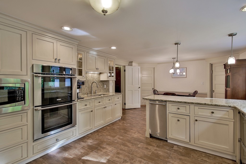 13 Spaulding Road Shirley, MA 01464 - Photo 7 of 27 a kitchen with white cabinets and stainless steel appliances