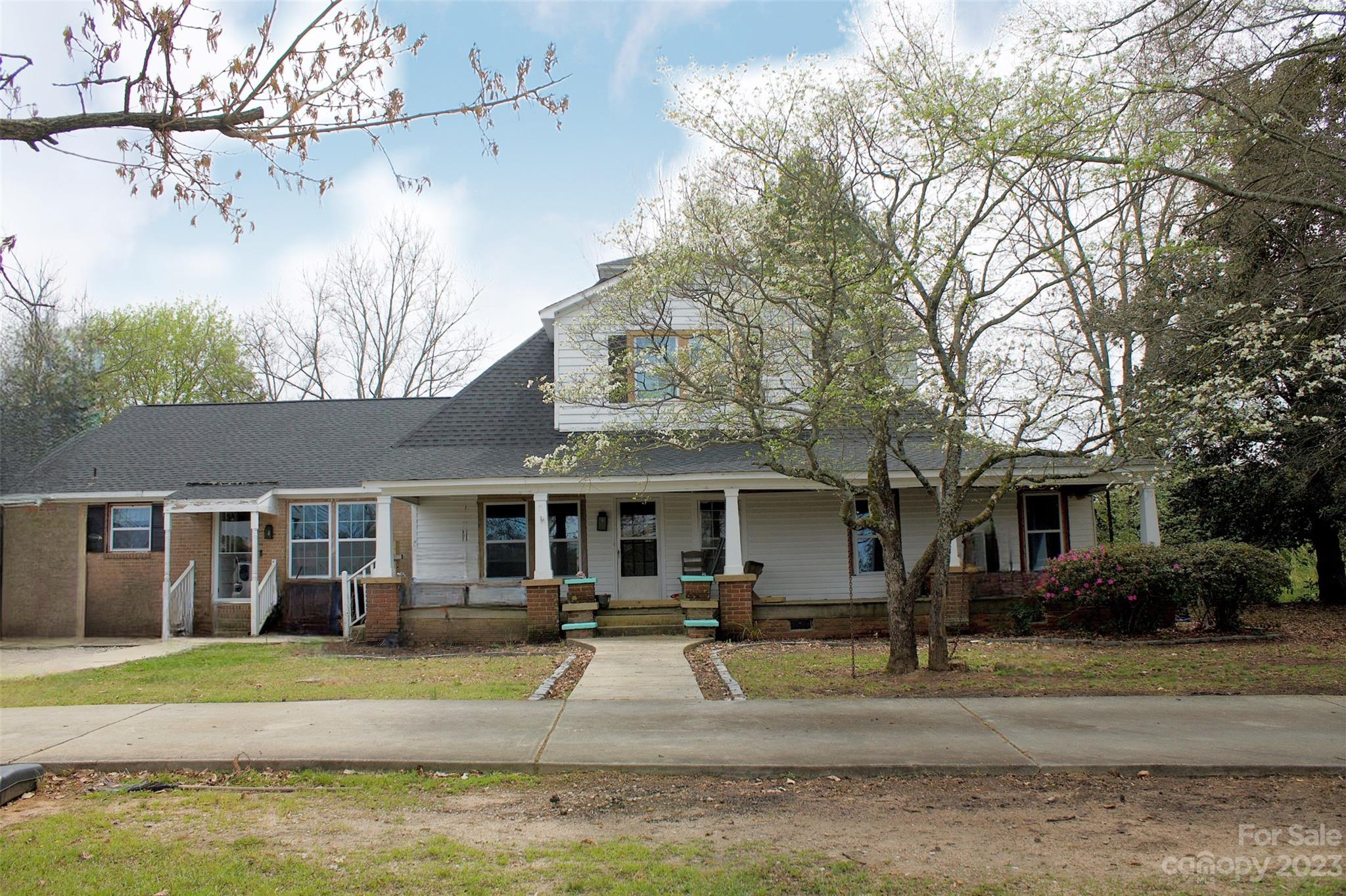 5880 Tabernacle Road Lancaster, SC 29720 - Photo 1 of 22 a view of a white house with a fountain plants and large trees