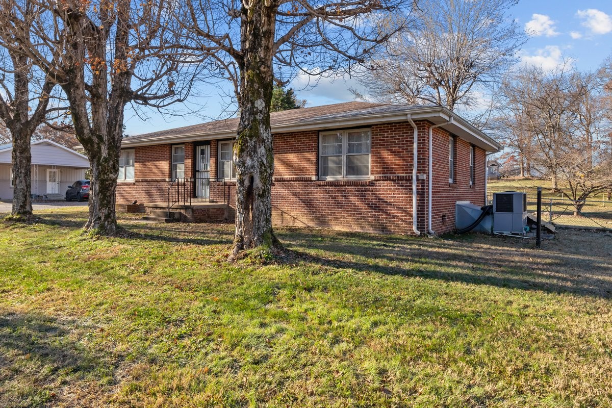 2138 River Road Clarksville, TN 37040 - Photo 26 of 27 a front view of a house with a yard covered with trees