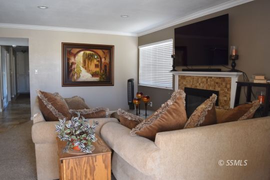 518 South Sanders Street Ridgecrest, CA 93555 - Photo 3 of 14 a living room with furniture a fireplace and a flat screen tv