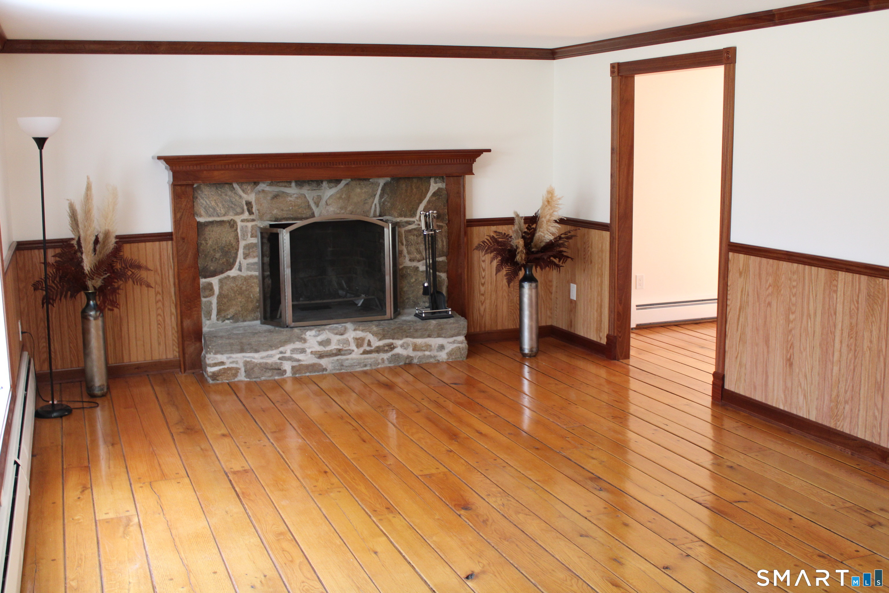 441 Opening Hill Road Madison, CT 06443 - Photo 22 of 33 a living room with a fireplace furniture and a wooden floor