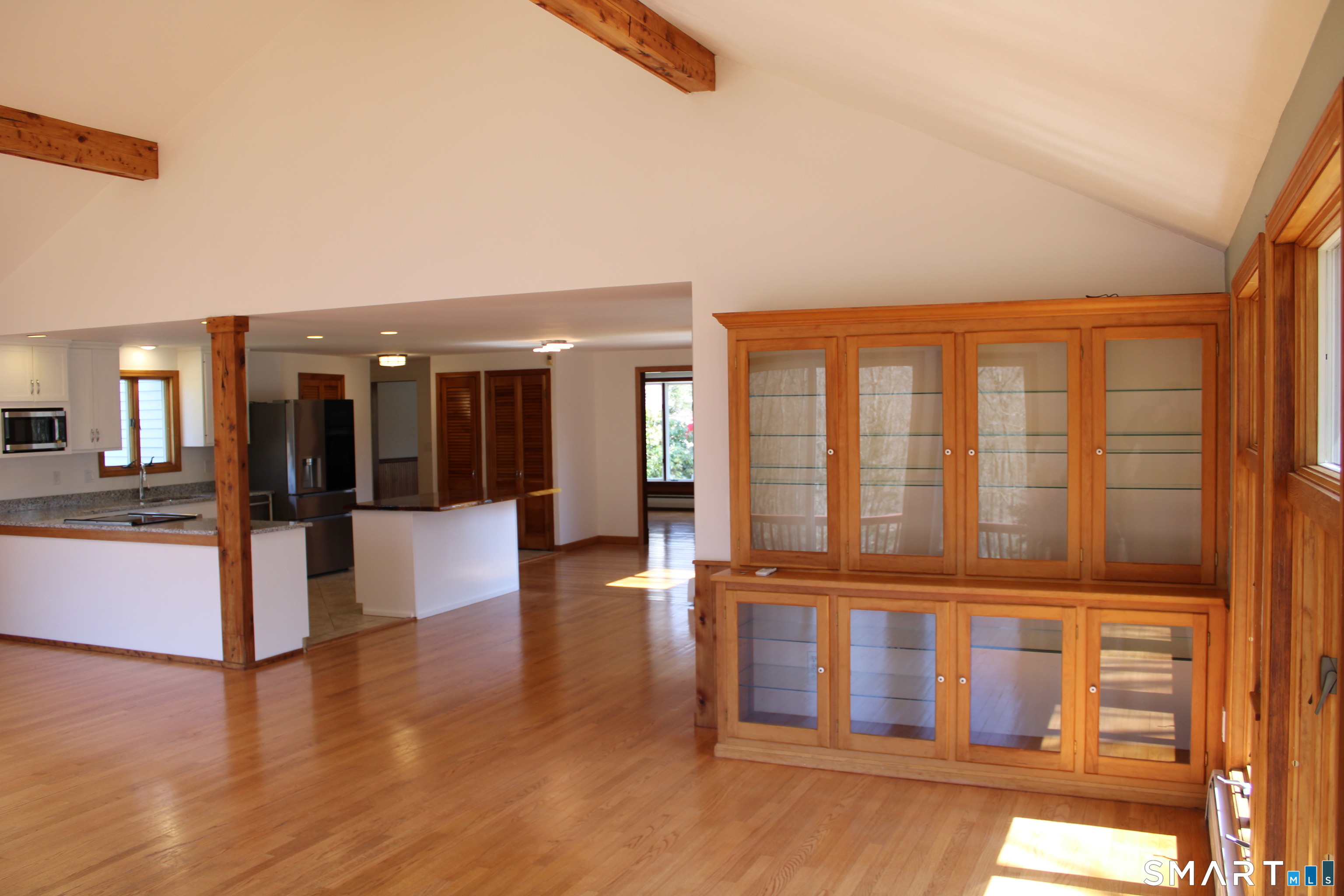 441 Opening Hill Road Madison, CT 06443 - Photo 23 of 33 a view of an entryway with wooden floor and a kitchen