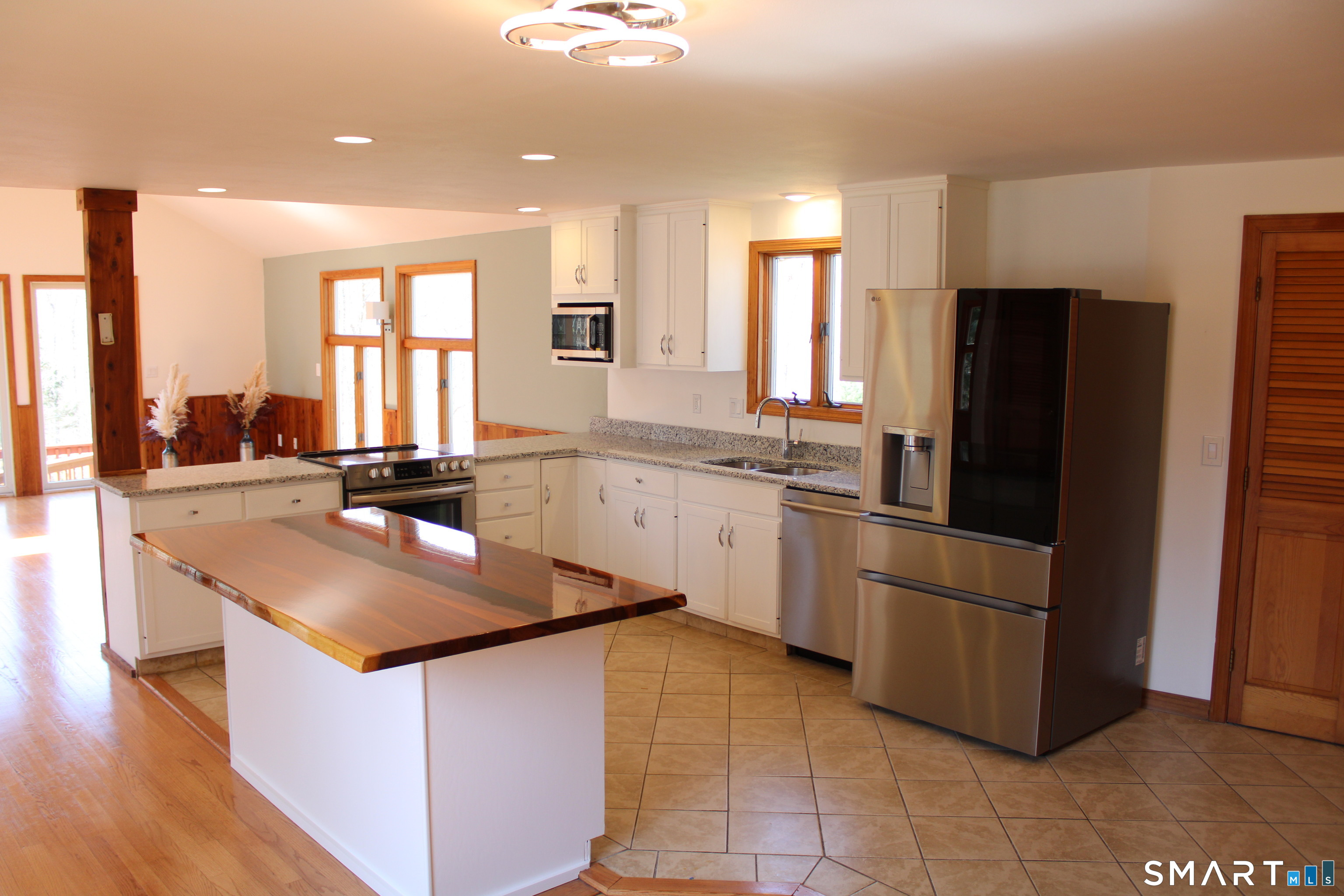 441 Opening Hill Road Madison, CT 06443 - Photo 26 of 33 a kitchen with stainless steel appliances granite countertop a sink stove and refrigerator