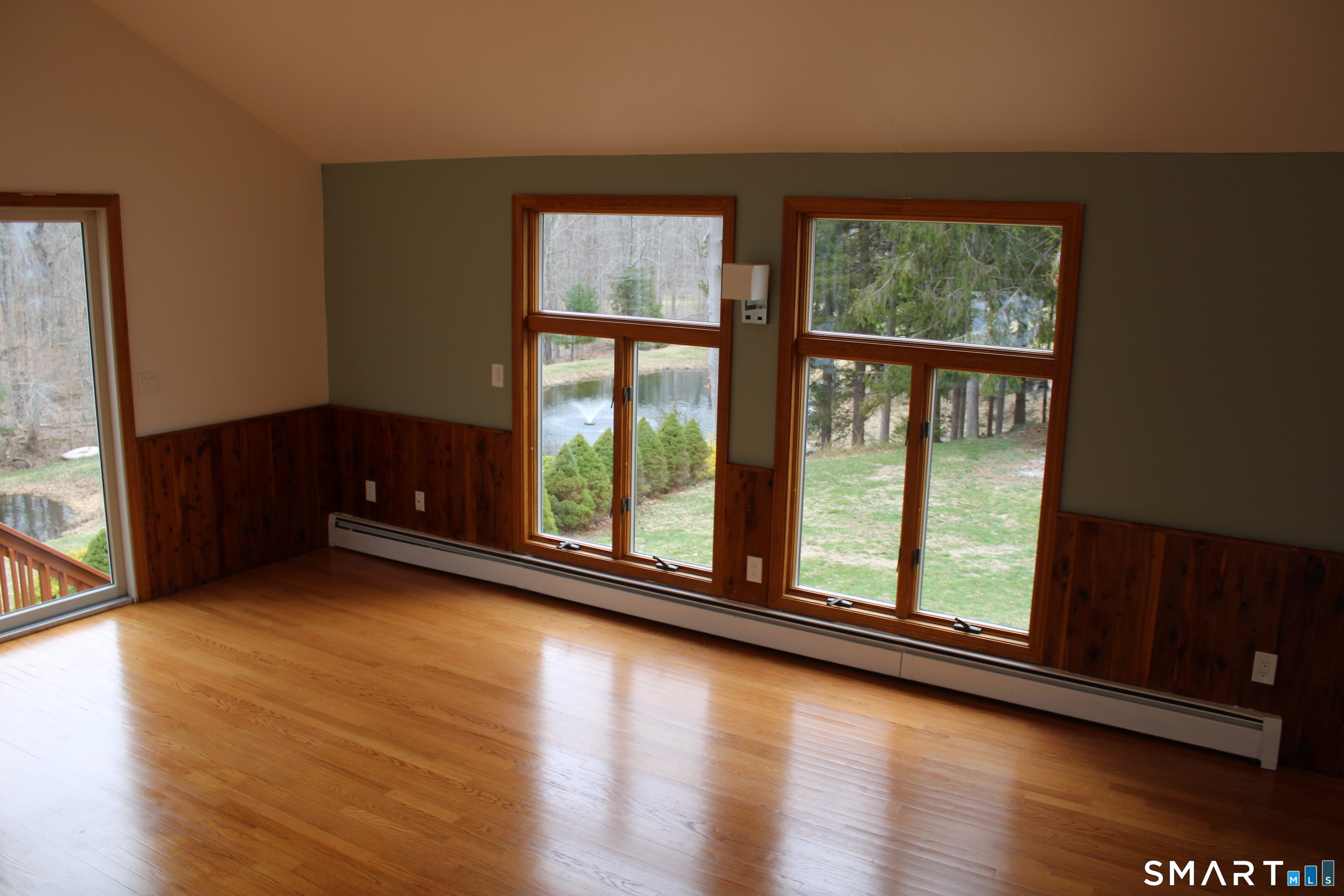 441 Opening Hill Road Madison, CT 06443 - Photo 6 of 33 a view of an empty room with wooden floor and a window