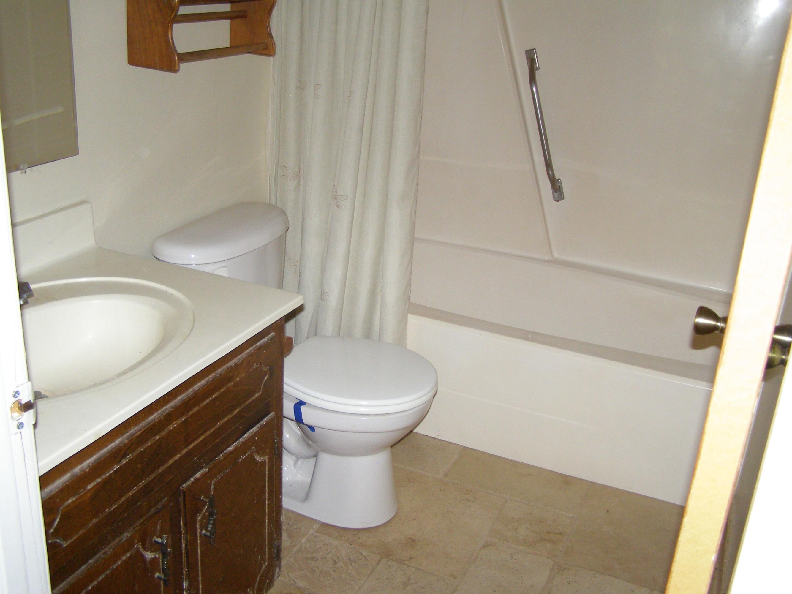 4263 Poverty Creek Road Crestview, FL 32539 - Photo 12 of 13 a bathroom with a toilet a sink and a mirror