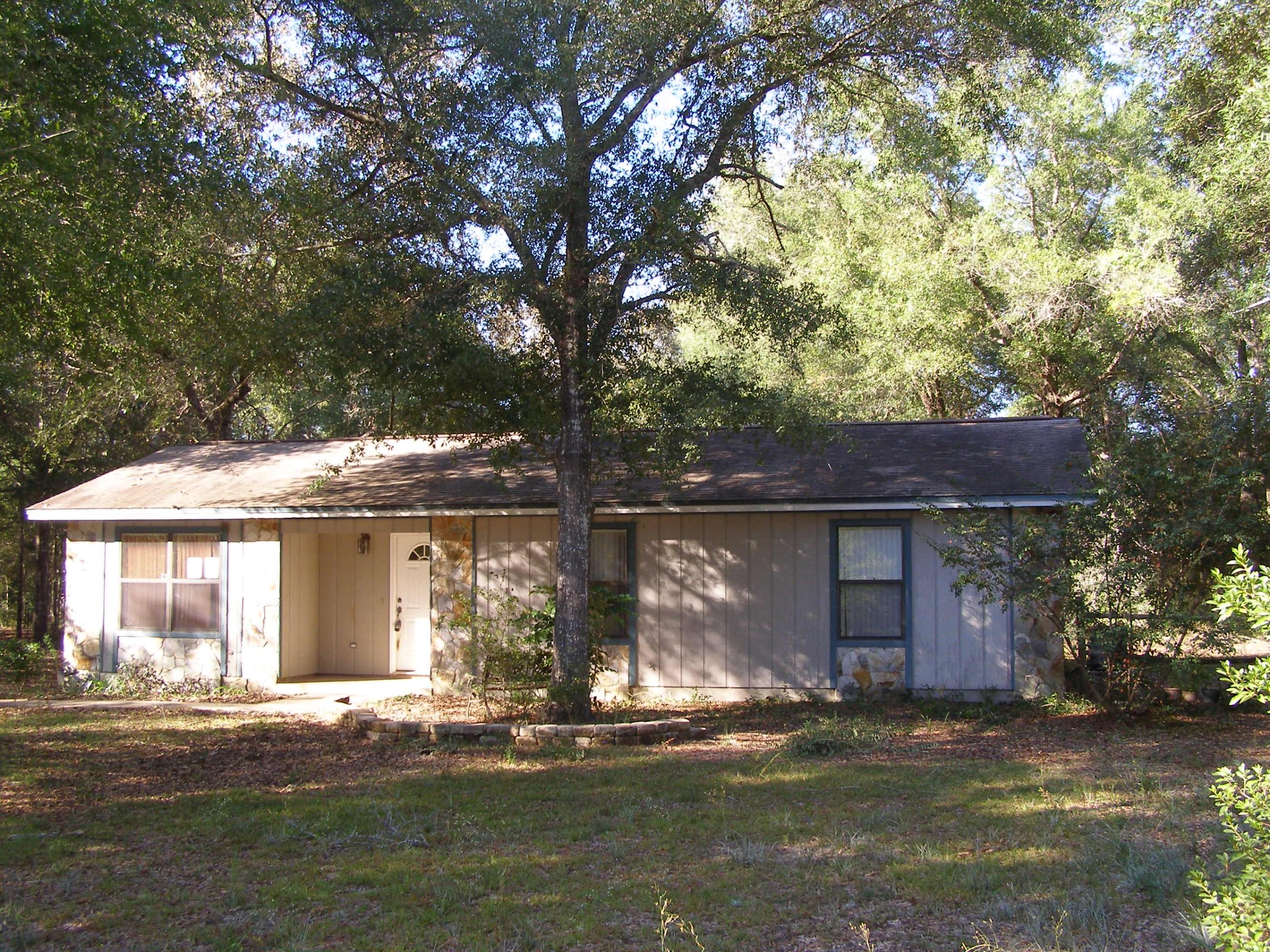4263 Poverty Creek Road Crestview, FL 32539 - Photo 13 of 13 a front view of a house with a garden