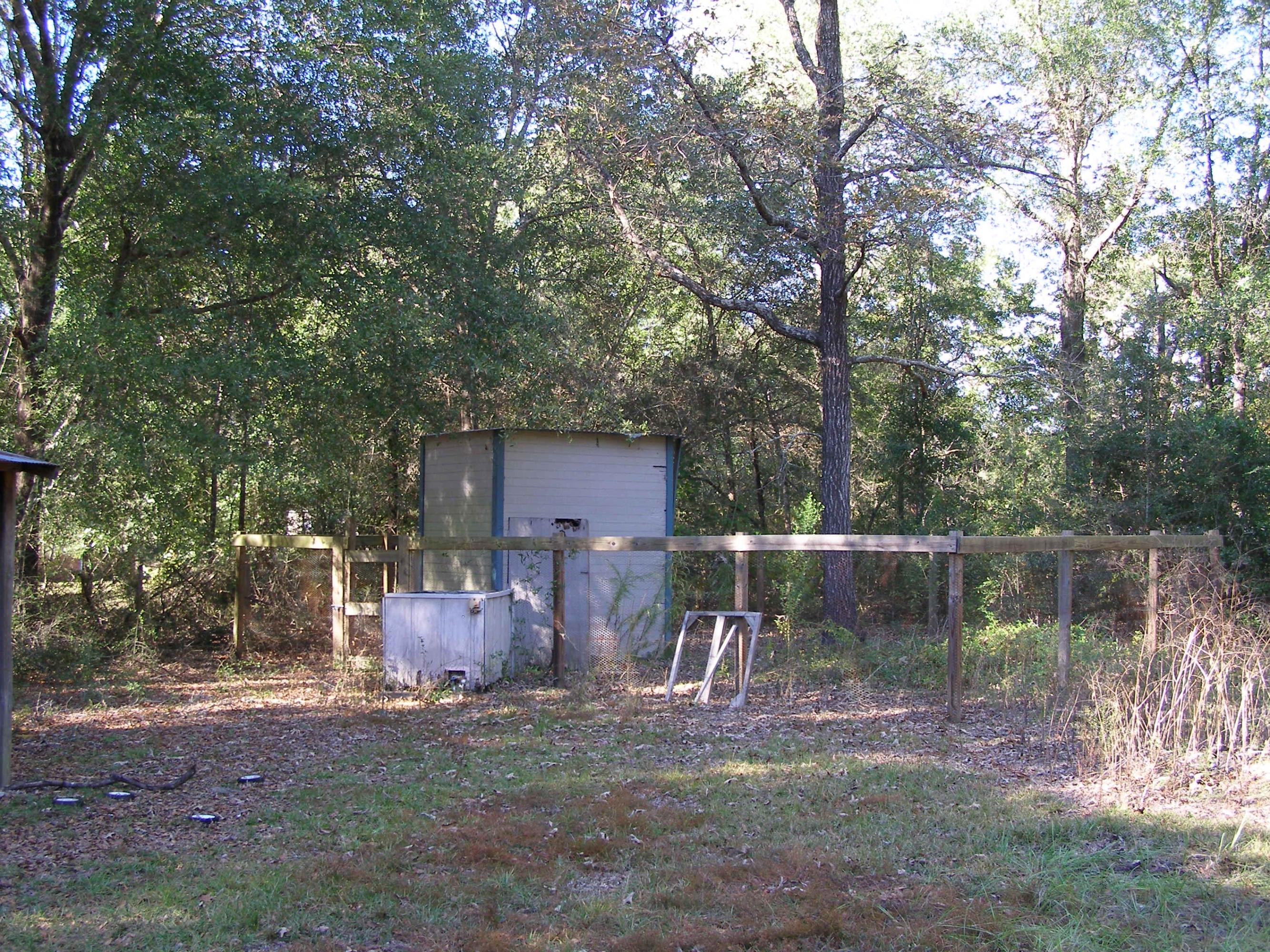 4263 Poverty Creek Road Crestview, FL 32539 - Photo 6 of 13 a backyard of a house with table and chairs