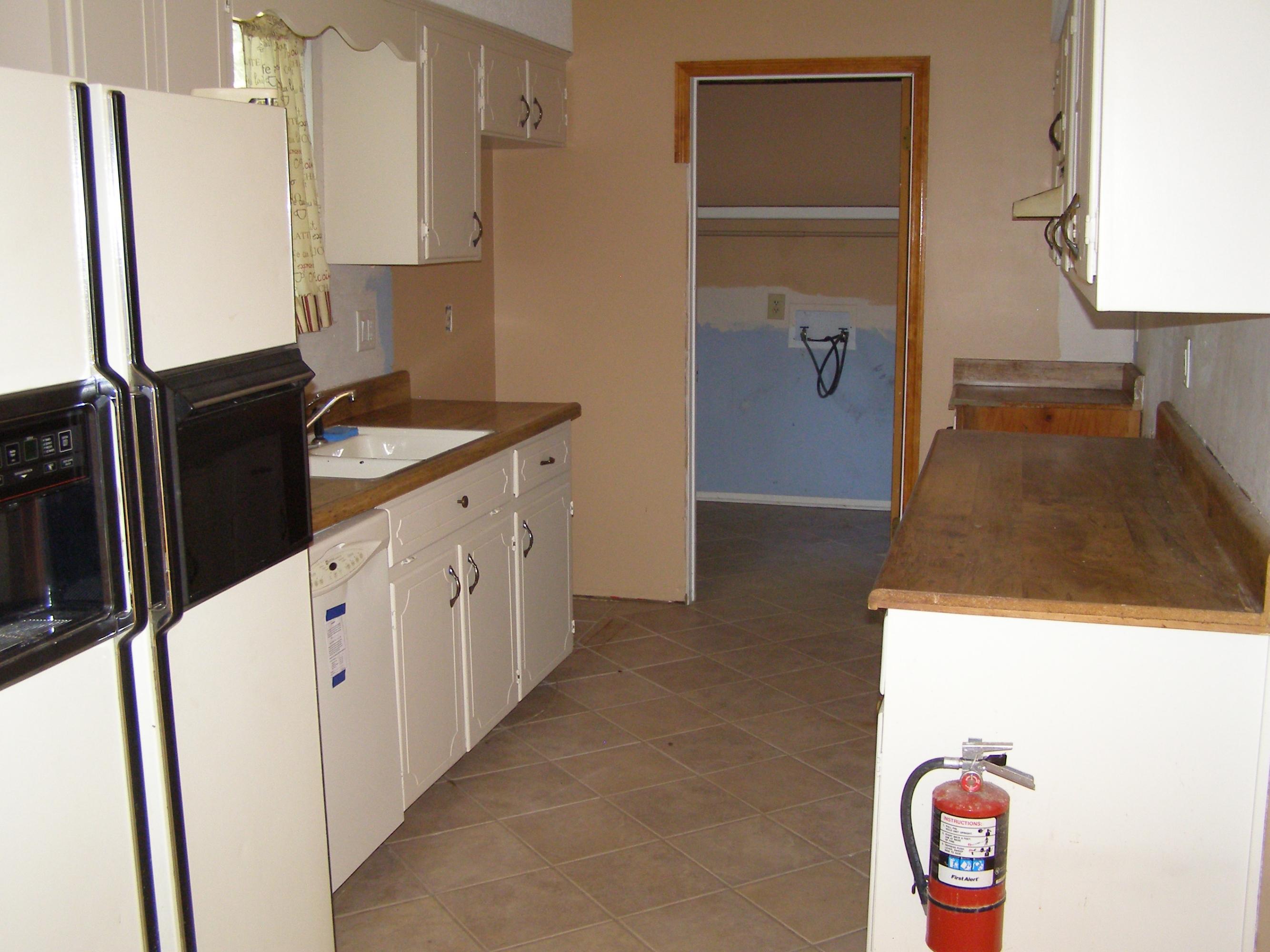 4263 Poverty Creek Road Crestview, FL 32539 - Photo 7 of 13 a kitchen with granite countertop a refrigerator and a stove
