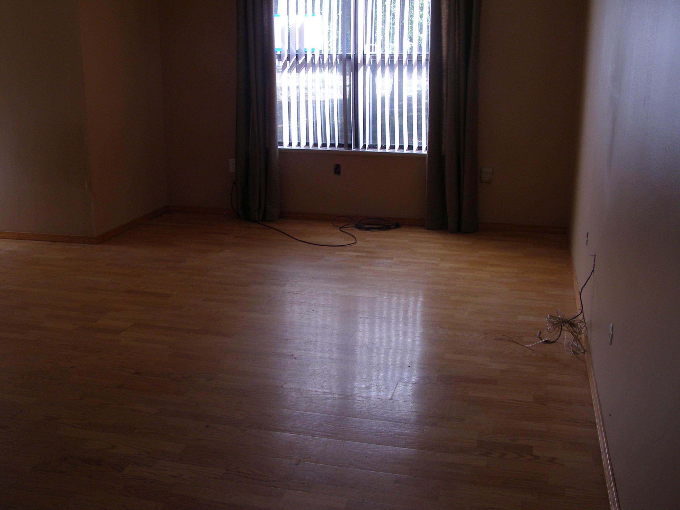 4263 Poverty Creek Road Crestview, FL 32539 - Photo 8 of 13 an empty room with wooden floor and windows