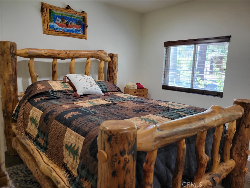 1116 Lark Road Wrightwood, CA 92397 - Photo 24 of 46 a bed sitting in a bedroom next to a window