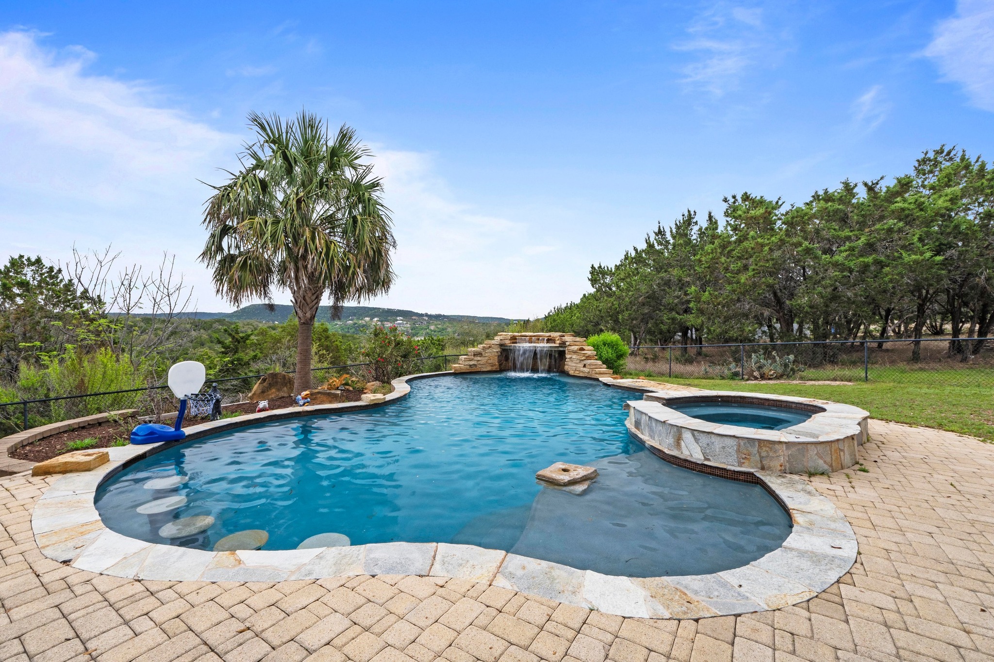 8211 Moon Rise Trail Jonestown, TX 78645 - Photo 25 of 34 Relax and rejuvenate in the saltwater pool with the serene sound of the waterfall.