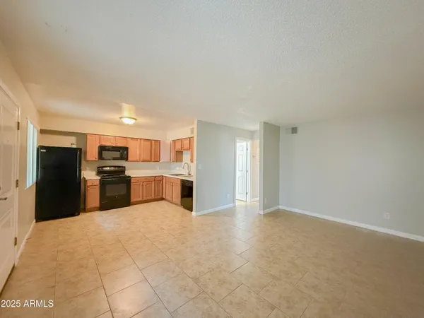 a kitchen with a sink cabinets and a window