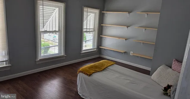 a bedroom with bed and window