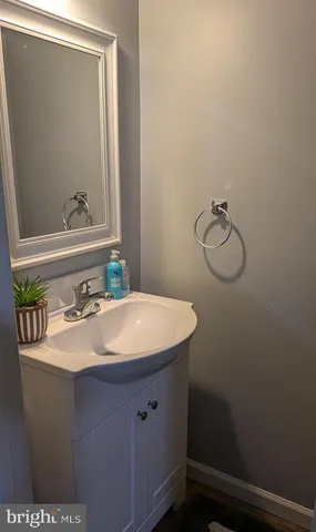 a bathroom with a sink vanity and a mirror