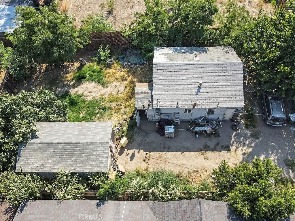an aerial view of a house with yard and seating space