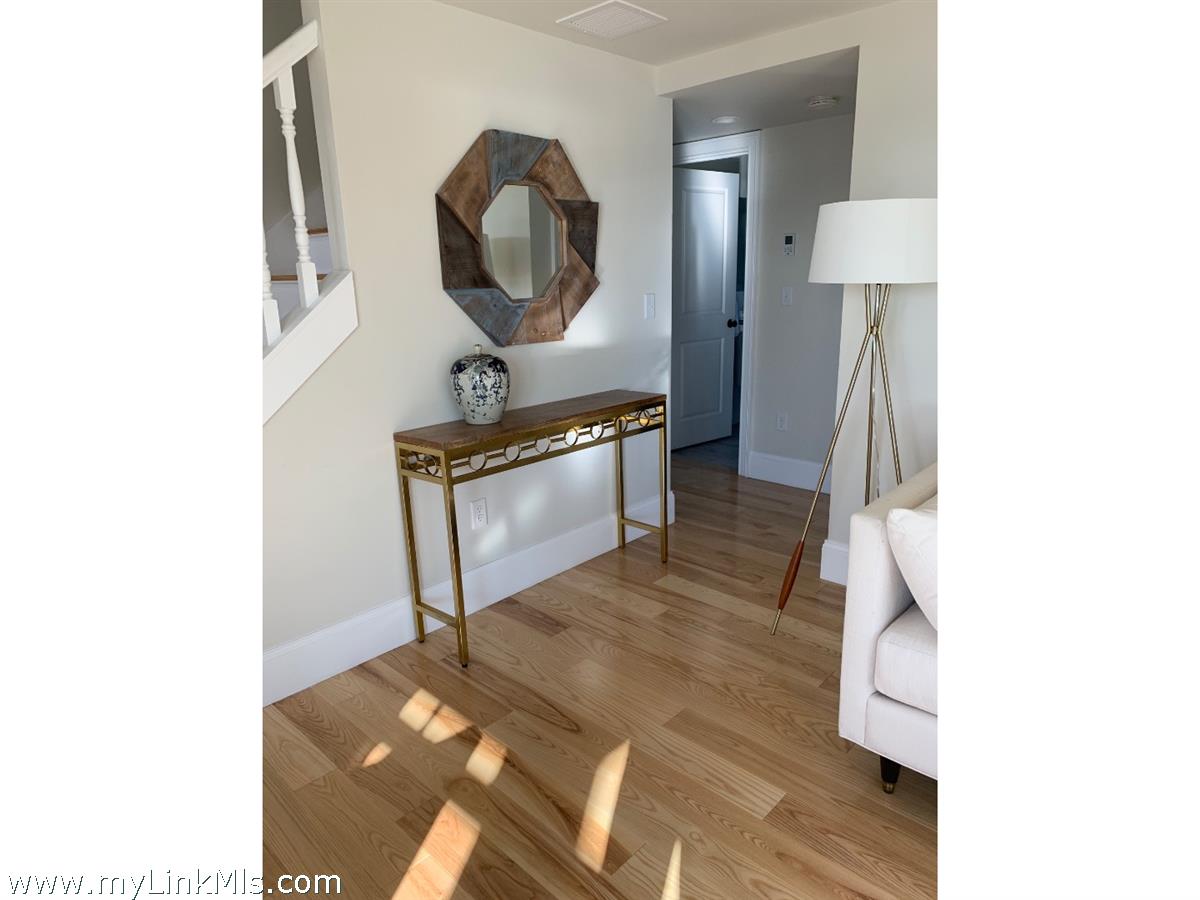 28 Beach Road Oak Bluffs, MA 02557 - Photo 11 of 32 a living room with furniture and a mirror