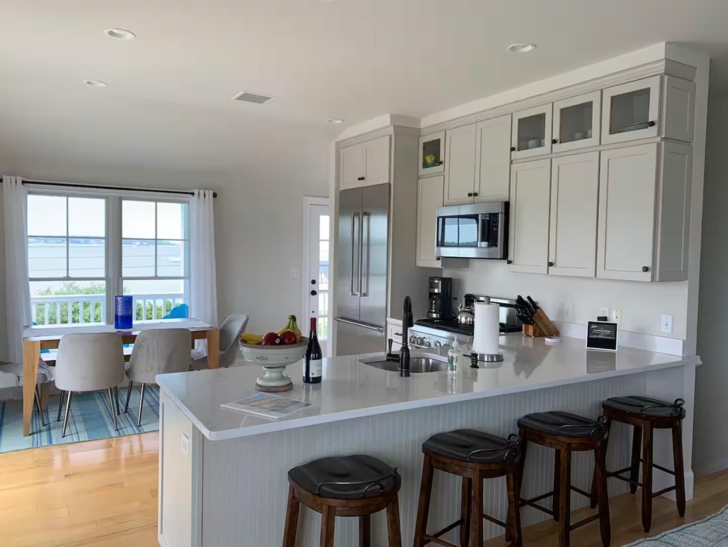 28 Beach Road Oak Bluffs, MA 02557 - Photo 19 of 32 a kitchen with a sink cabinets and wooden floor