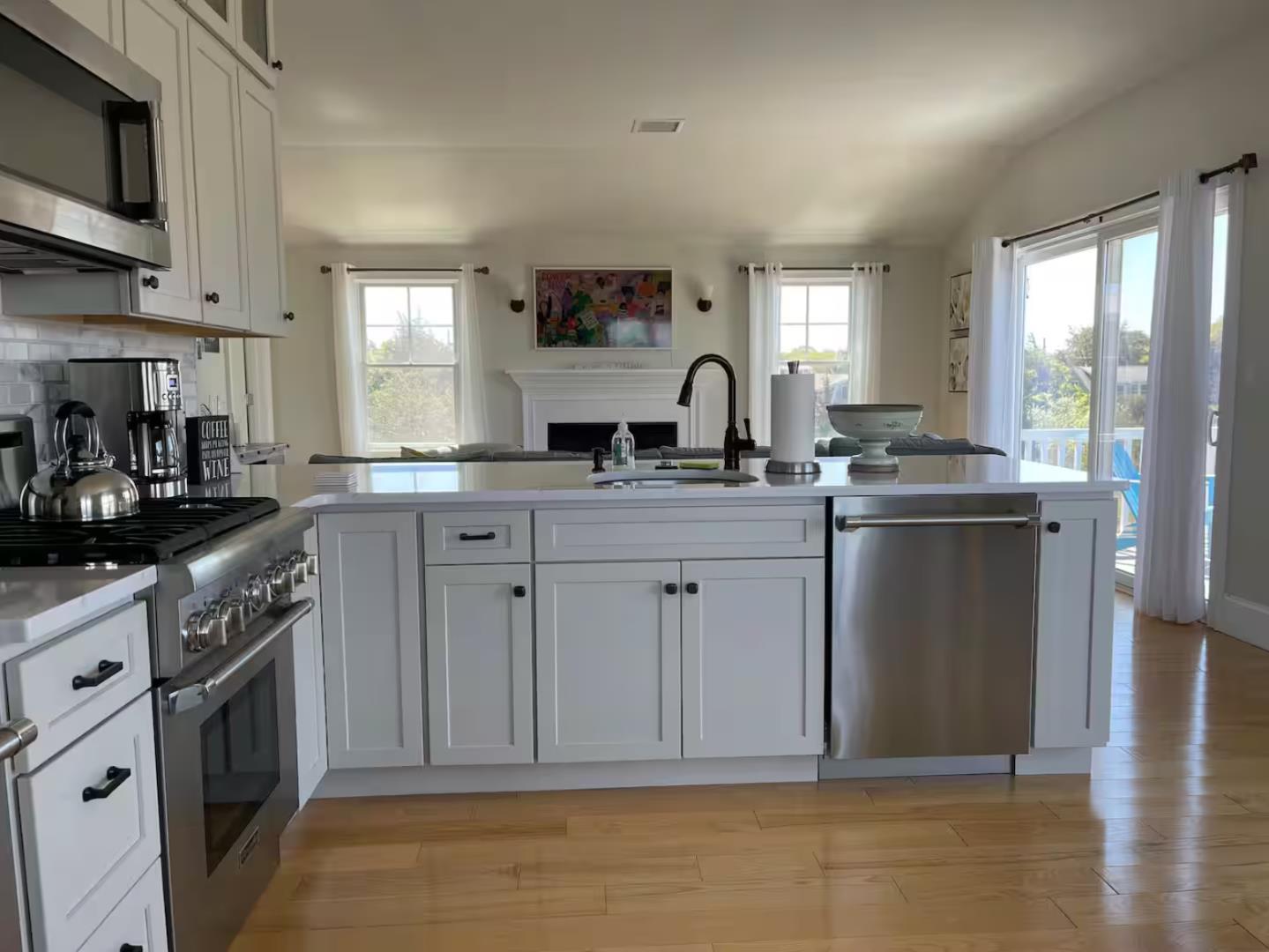 28 Beach Road Oak Bluffs, MA 02557 - Photo 22 of 32 a kitchen with stainless steel appliances granite countertop a sink a stove a refrigerator cabinets and a window