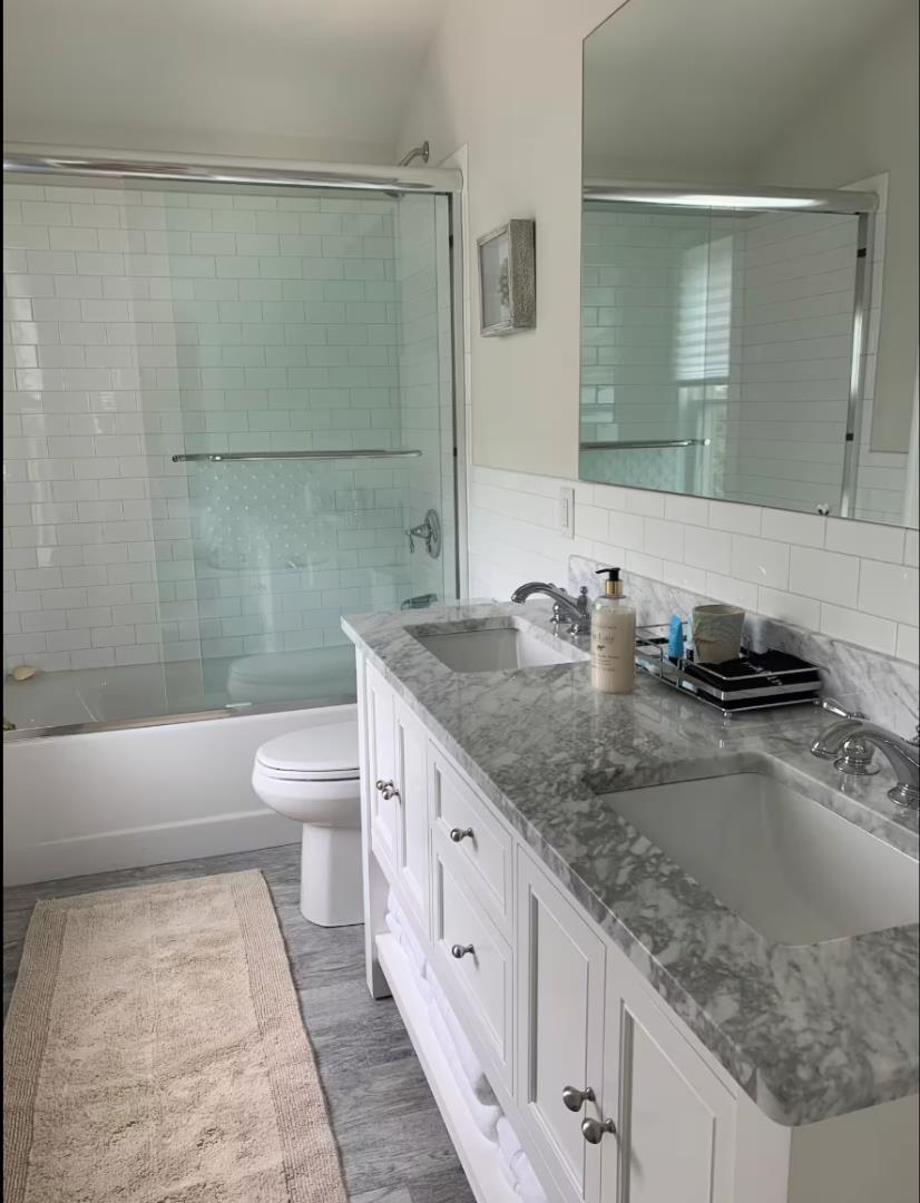 28 Beach Road Oak Bluffs, MA 02557 - Photo 24 of 32 a bathroom with a granite countertop sink a toilet and shower