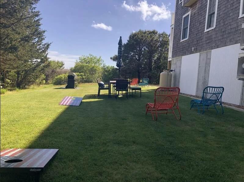 28 Beach Road Oak Bluffs, MA 02557 - Photo 31 of 32 a view of a table and chairs in the patio