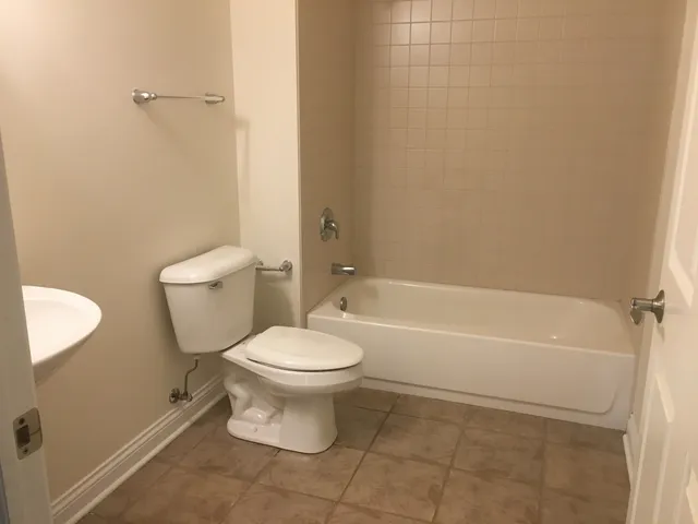 a bathroom with a toilet and a bathtub