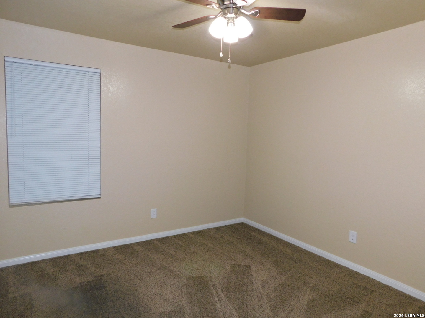 8710 8th Street, Unit 2 Converse, TX 78109 - Photo 11 of 18 an empty room with a chandelier fan