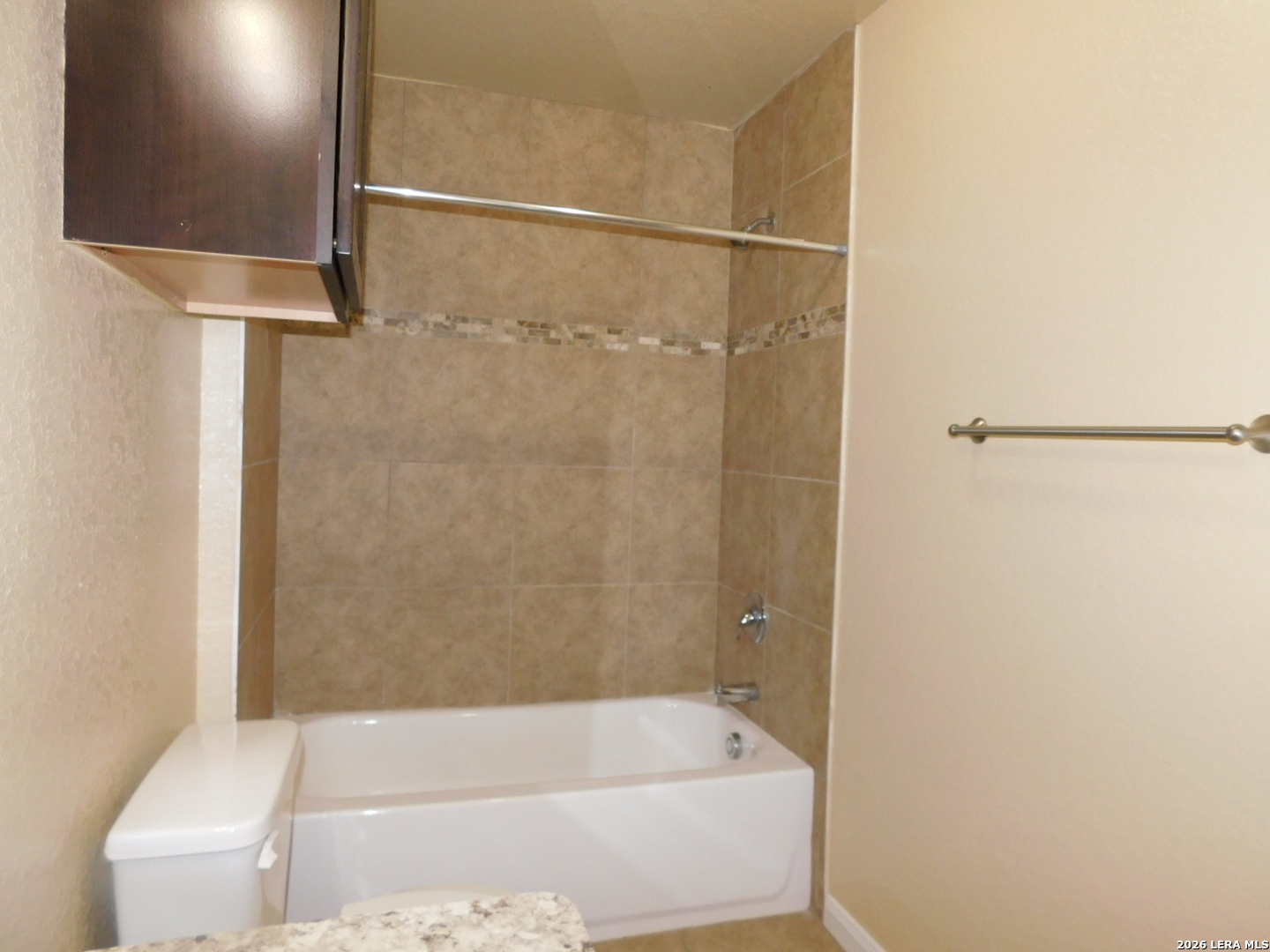 8710 8th Street, Unit 2 Converse, TX 78109 - Photo 14 of 18 a bathroom with a bathtub and a shower