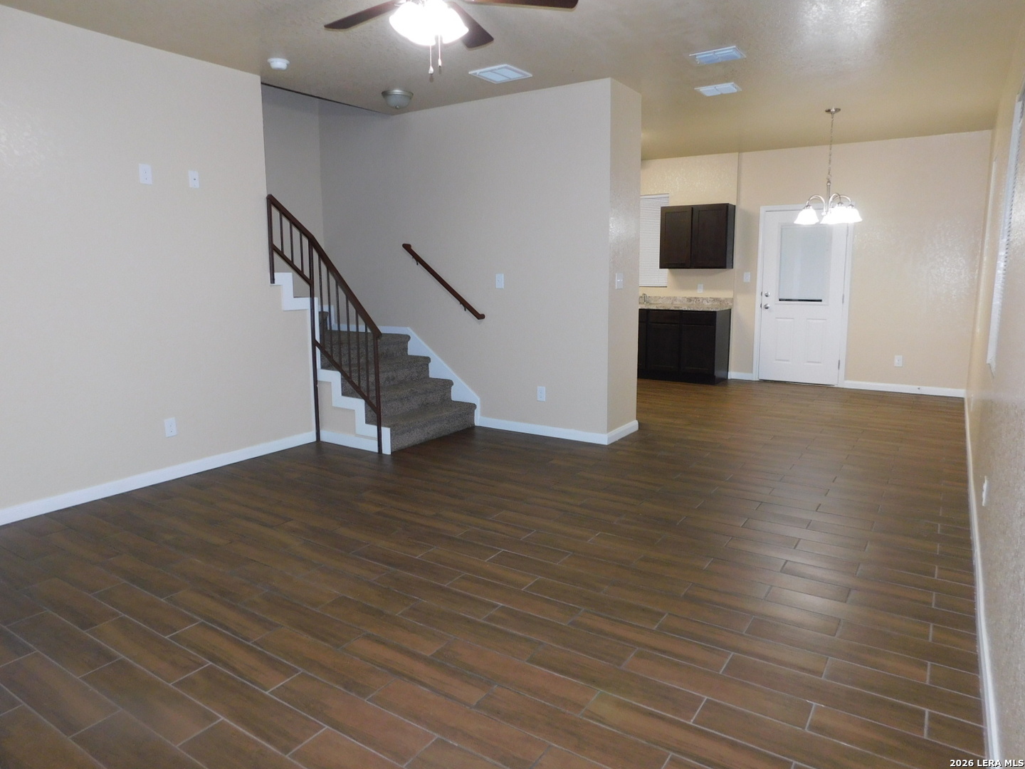 8710 8th Street, Unit 2 Converse, TX 78109 - Photo 2 of 18 an empty room with wooden floor and a fireplace