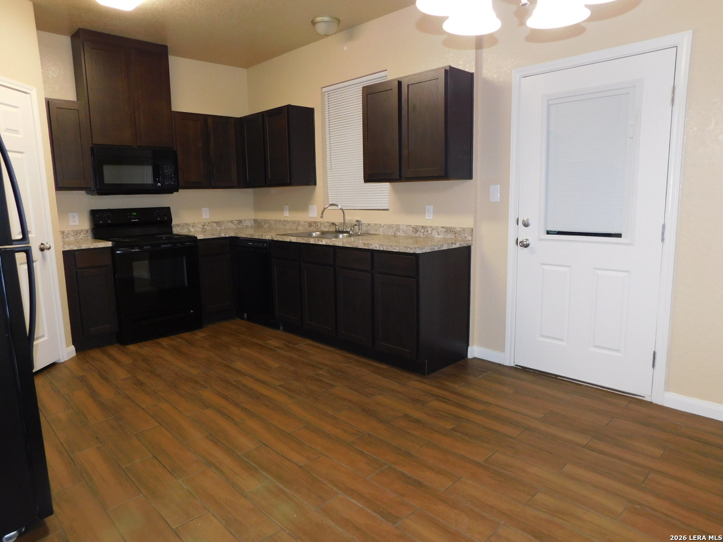 8710 8th Street, Unit 2 Converse, TX 78109 - Photo 5 of 18 a kitchen with stainless steel appliances granite countertop a refrigerator and a stove top oven