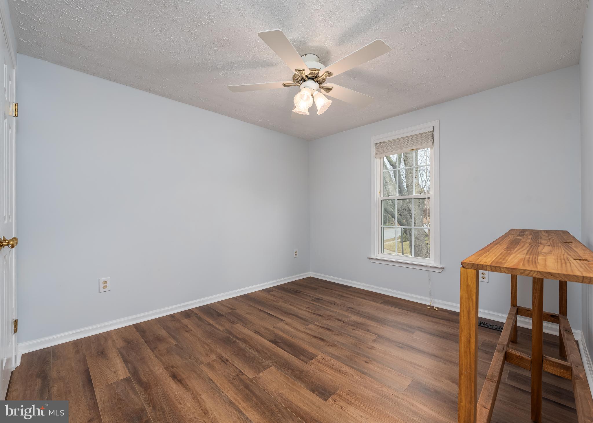 7202 Single Wheel Path Columbia, MD 21046 - Photo 20 of 30 a view of an empty room with wooden floor and a window