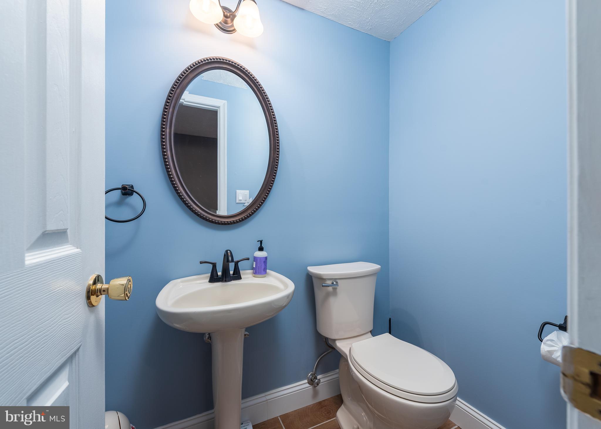 7202 Single Wheel Path Columbia, MD 21046 - Photo 24 of 30 a bathroom with a toilet sink and mirror