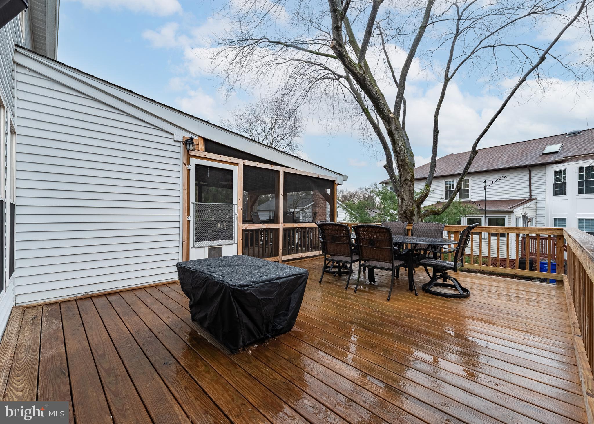 7202 Single Wheel Path Columbia, MD 21046 - Photo 28 of 30 a view of a roof deck with table and chairs wooden floor and fence