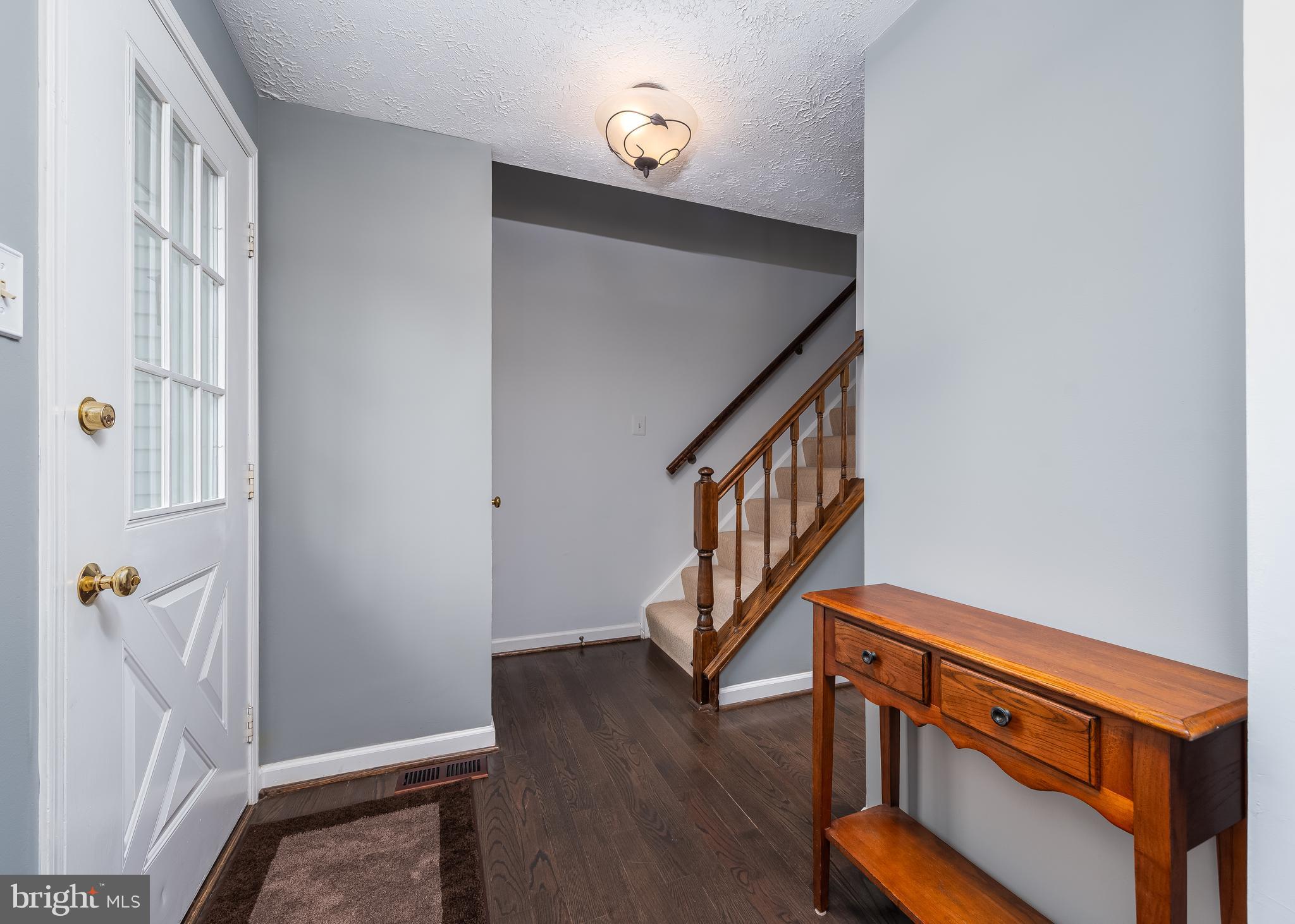 7202 Single Wheel Path Columbia, MD 21046 - Photo 3 of 30 a view of an entryway with wooden floor