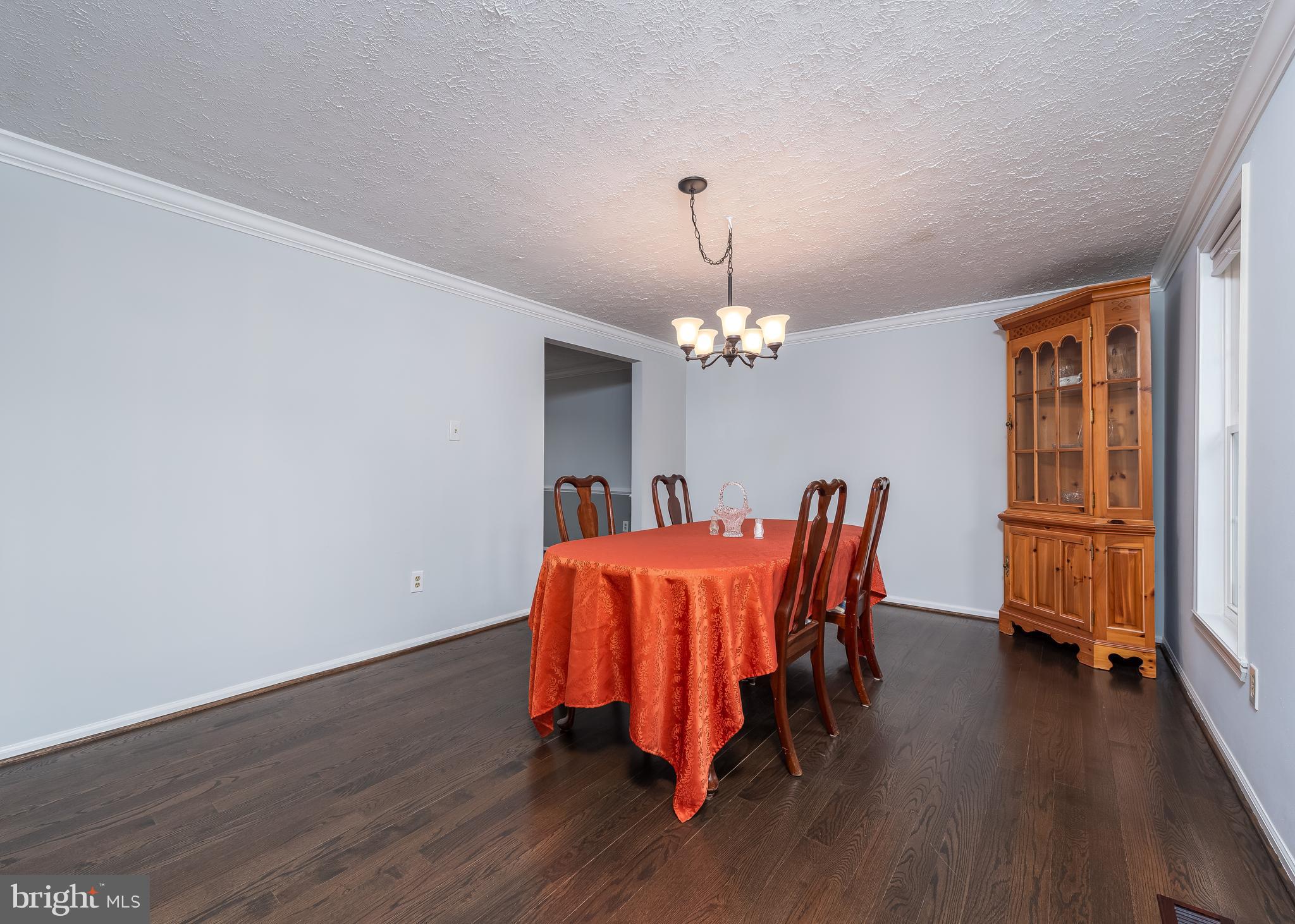 7202 Single Wheel Path Columbia, MD 21046 - Photo 4 of 30 a view of a dining room with furniture wooden floor and chandelier