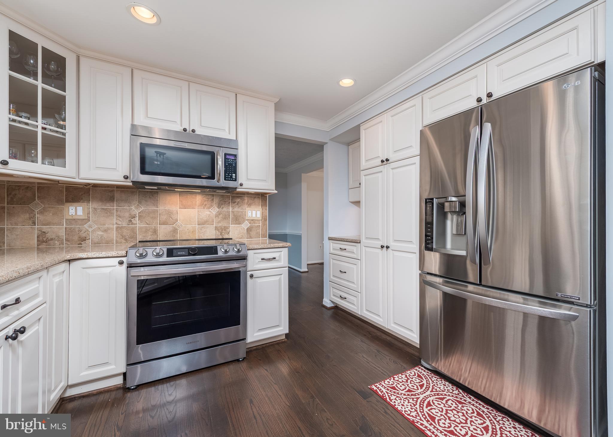 7202 Single Wheel Path Columbia, MD 21046 - Photo 7 of 30 a kitchen with a refrigerator stove and microwave