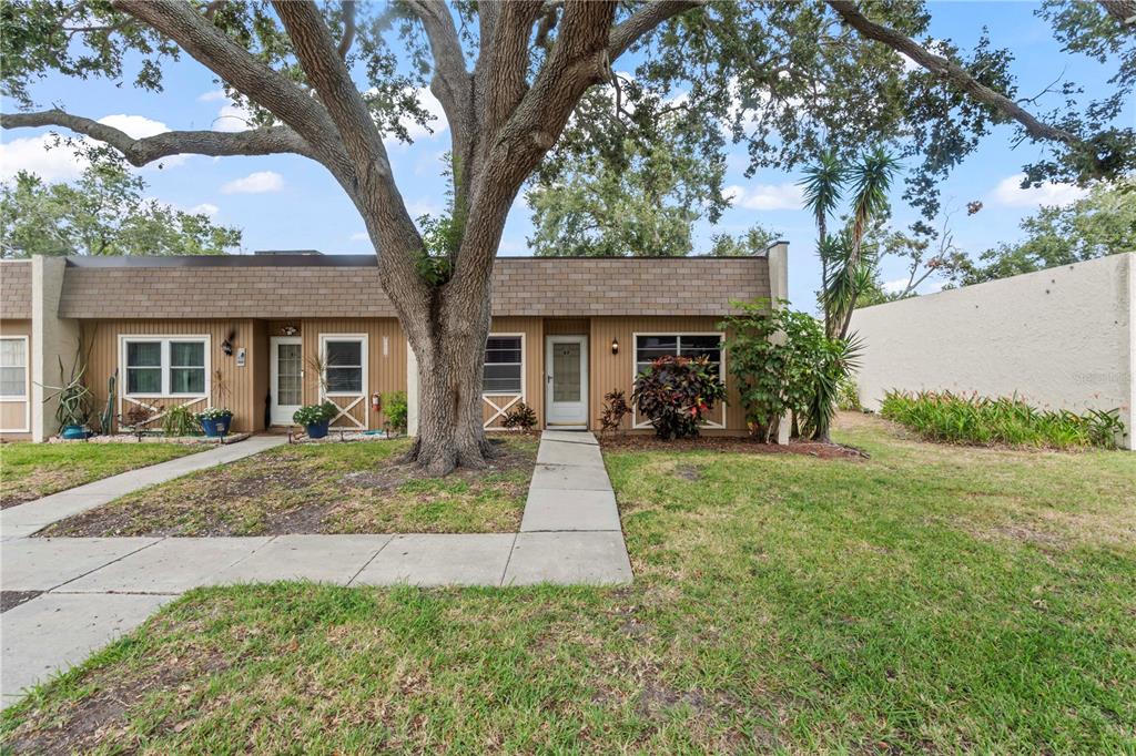 11511 113th Street, Unit 4F Largo, FL 33778 - Photo 1 of 30 front view of a house with a yard
