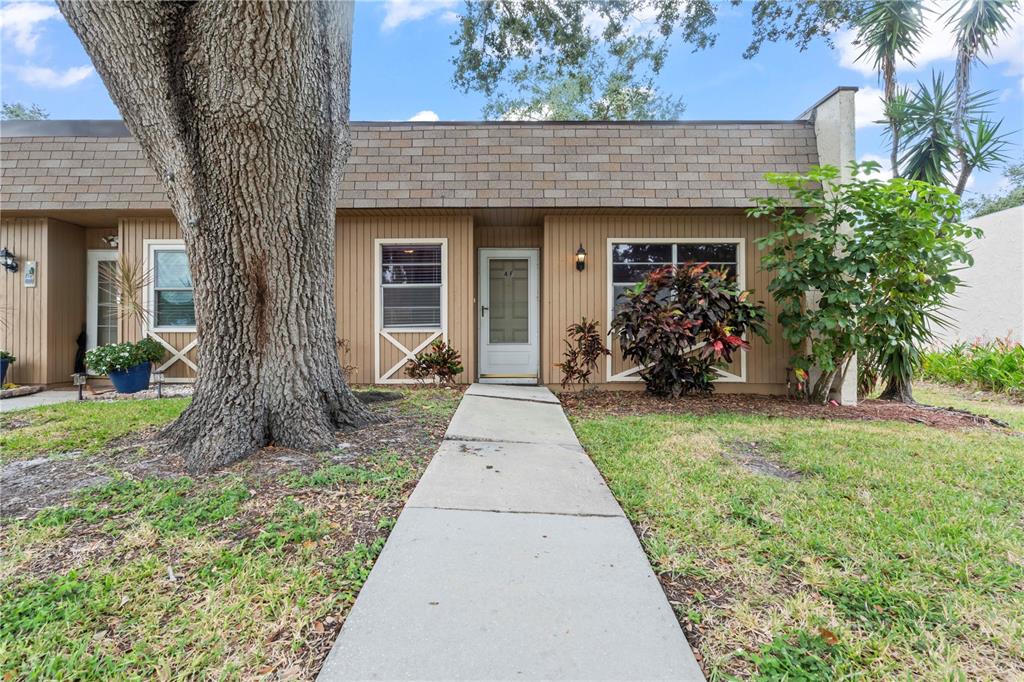 11511 113th Street, Unit 4F Largo, FL 33778 - Photo 30 of 30 front view of a house with a yard