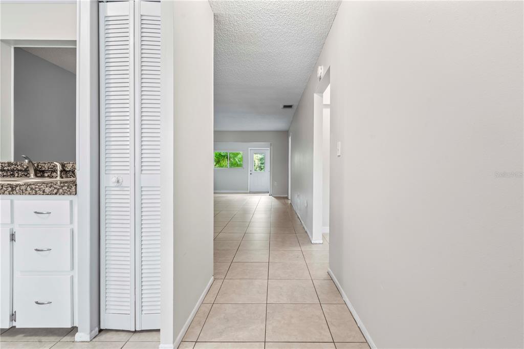 11511 113th Street, Unit 4F Largo, FL 33778 - Photo 3 of 30 a view of hallway with livingroom and wooden floor