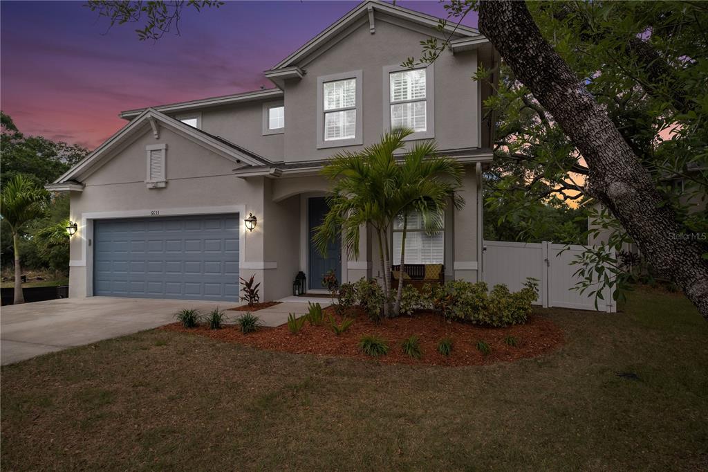 a front view of a house with garden
