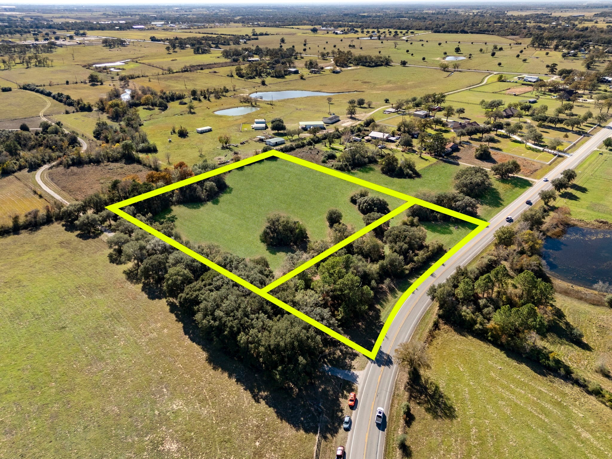 7.54 acres of partially wooded land with 675 feet of FM 1488 road frontage.