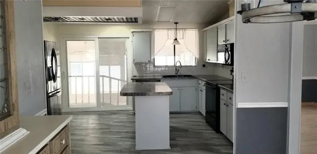 a kitchen with a sink cabinets and window