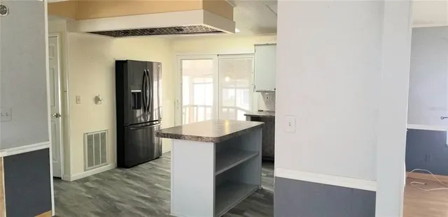 a kitchen with a refrigerator and a sink